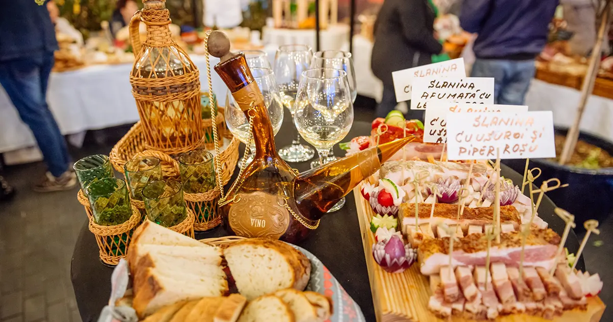 A close-up of traditionally smoked Transylvanian bacon (slănină) displayed on a wooden board at SlanaFest, Cluj-Napoca.